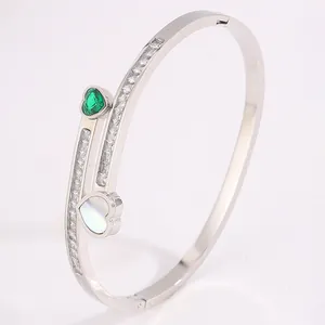 Polished silver-tone open bangle with green heart gem and white mother-of-pearl heart