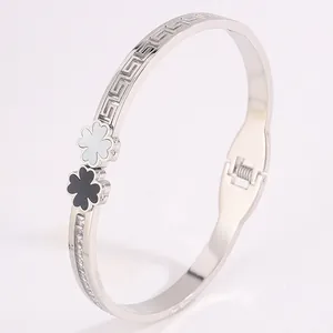 Silver stainless steel open bangle with black and white clover and Greek key pattern