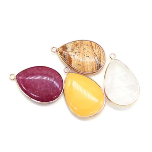 Teardrop gemstone pendant set with four natural stones and gold-plated metal edges