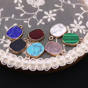 Oval natural stone pendants with gold plated borders including malachite and lapis lazuli