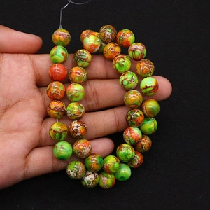 Macro detail of colorful imperial stone round beads with natural marble crackle patterns