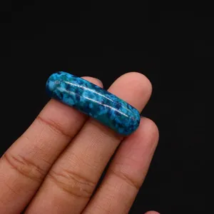 Close-up of a blue-green phoenix stone curved tube bead for DIY jewelry making