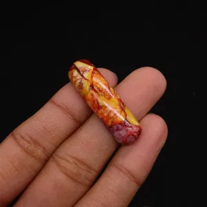 Macro shot of curved Emperor stone pendant with colorful natural veins and smooth finish