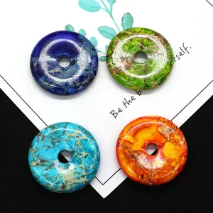 Polished natural stone donut pendants in deep blue, green, and orange for DIY jewelry making