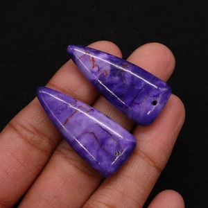 Macro shot of triangular purple natural stone pendants with natural mineral textures