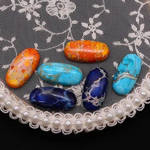 Oval dyed emperor stone cabochons in orange and blue with natural marble texture