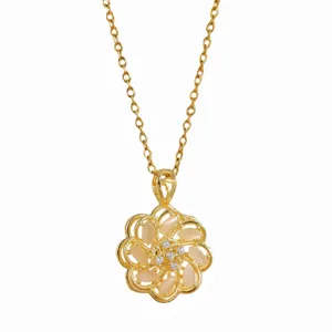 Rotating flower pendant necklace in gold finish with cat eye stone petals and zircons