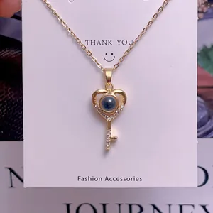 Detail shot of heart key pendant featuring micro-projection stone and zircon accents