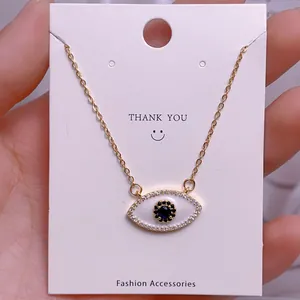 Makroaufnahme der Evil-Eye-Halskette mit blauem Stein und goldener Gliederkette