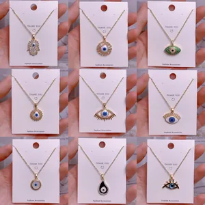 Goldene Evil Eye und Hamsa Hand Halsketten-Set mit blauen Kristallen auf Karten