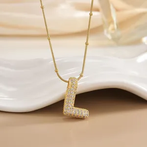 Detail showing gold letter L pendant with micro-paved cubic zirconia on a snake bead chain
