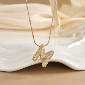 Detail of 18K gold plated M letter pendant necklace with micro-pave cubic zirconia