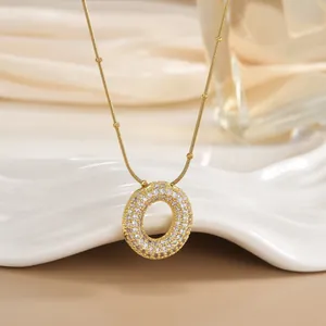 Macro detail of gold-plated pendant necklace with micro-paved cubic zirconia stones