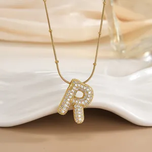 Close-up of 18K gold plated letter R pendant with micro-pave cubic zirconia on bead chain