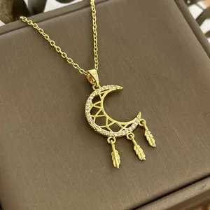 Elegant gold dreamcatcher crescent moon necklace with feathers and sparkling crystals