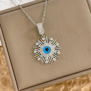 Turkish evil eye sunburst pendant necklace in silver stainless steel with blue resin eye