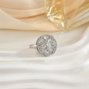 Elegant rotating floral ring with marquise-cut zircons displayed on a textured white plate