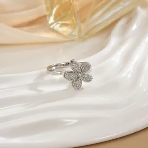Detail of a rotating five-petal flower ring with micro-pave zircons and open design