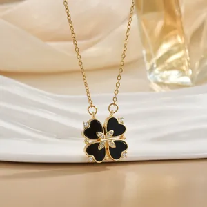 Elegant gold necklace featuring a black clover pendant with heart shapes and small diamonds