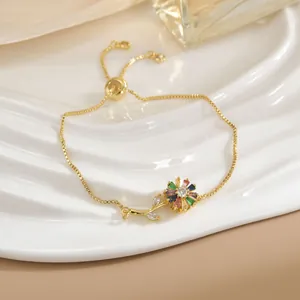 Dettaglio del bracciale a catena dorata con ciondolo a fiore di gemme colorate e chiusura scorrevole