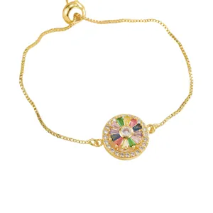Elegante bracciale dorato con cristalli di zircone colorati e chiusura a scorrimento