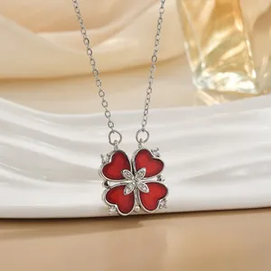 Silver four-leaf clover necklace with red heart-shaped petals and zircon accents