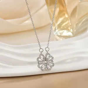 Close-up of silver clover necklace with heart petals and white zircon micro-pave