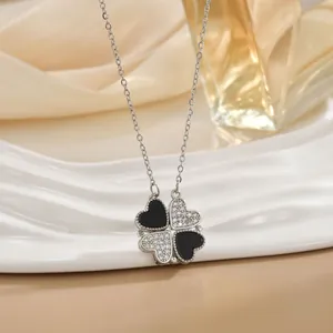 Magnetic four-leaf clover heart necklace in silver finish on a white display stand