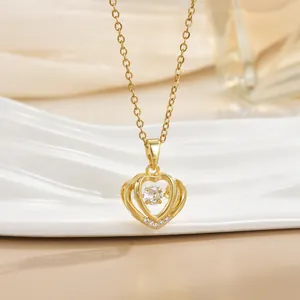 Macro shot of gold-plated heart necklace featuring a dancing central zircon crystal