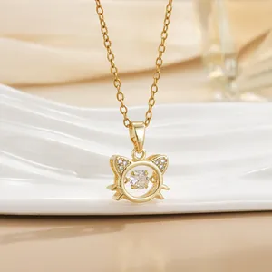 Macro detail of dancing stone gold cat pendant with shimmering cubic zirconia accents