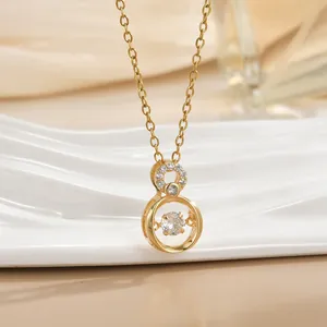 Gold titanium steel necklace with infinity sparkling zircon pendant on silk background