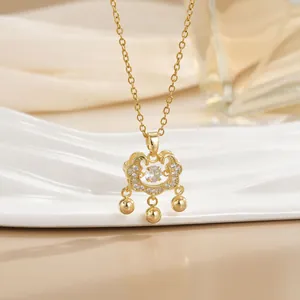 Detailed view of a gold Ruyi lock necklace with pavé zircons and three small bells