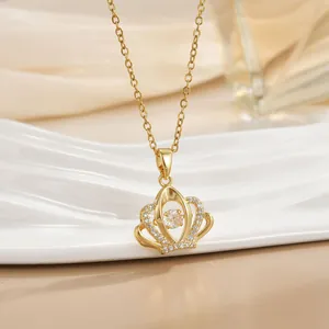 Macro view of gold crown pendant necklace with shimmering crystals and dancing heart stone