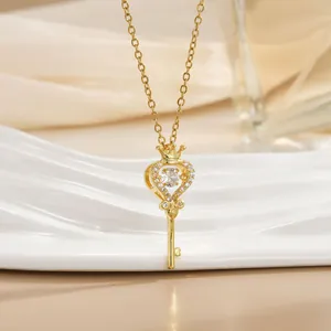 Elegant gold heart-shaped key pendant necklace with sparkling stones and crown detail