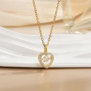 Macro shot of gold heart necklace featuring a dancing stone and pavé setting