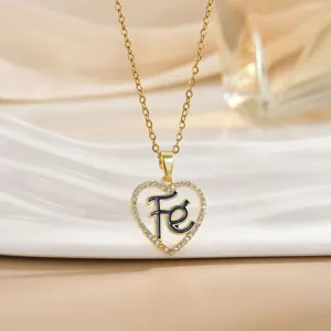 Golden heart pendant necklace with micro-pave crystals and Fe letter on a chain