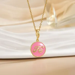 Gold chain necklace with a pink enamel Fe pendant featuring a small heart decoration