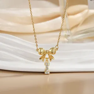 Detailed macro view of gold-plated necklace with sparkling bow and zircon letter I pendant