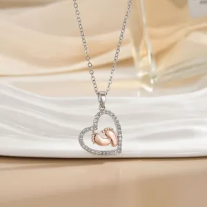 Two-tone heart necklace with baby footprints and sparkling cubic zirconia for Mother Day