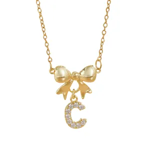 Gold tone bow necklace with zircon letter C pendant made of durable titanium steel