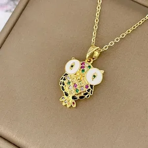 Golden owl pendant necklace with colorful gemstones and white enamel eyes on a gold chain