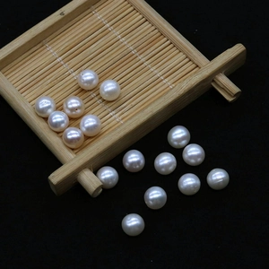 Macro view of high-luster cream white freshwater pearls with holes for DIY jewelry