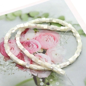 Macro detail of cube-shaped natural shell beads with pearlescent finish for DIY jewelry