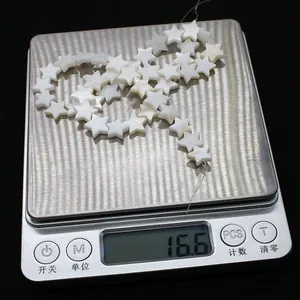 Star-shaped white freshwater shell beads for jewelry making weighing 16.6g on scale