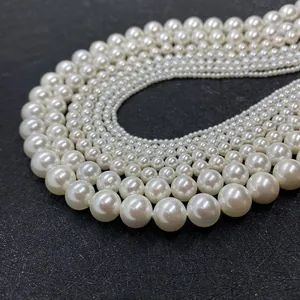 Macro view of gradient size white faux pearls with glossy finish and polished surface