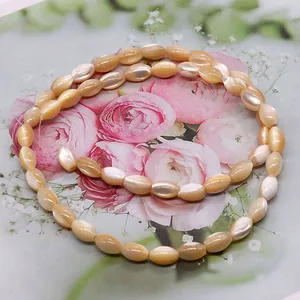 Macro shot of oval rice-shaped natural shell beads with soft champagne pink luster