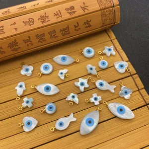 Natural sea shell evil eye charms set with golden rings for DIY jewelry making
