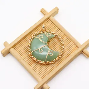 Detailed wire-wrapped crescent moon opal pendant set in a golden round frame