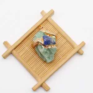 Detailed macro view of natural green raw stone pendant with gold irregular metal edging