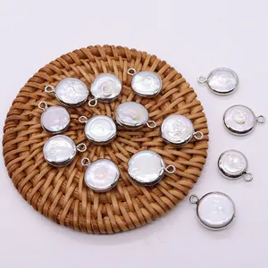 Natural freshwater pearl round pendant with silver plated metal edge on woven mat